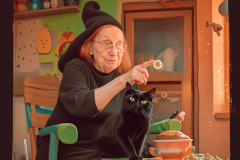 Grandmasterp_Witch_sits_with_her_black_cat_in_the_crunchy_house_6a312ccb-9603-4eb5-b7e1-ce0799549d70-1