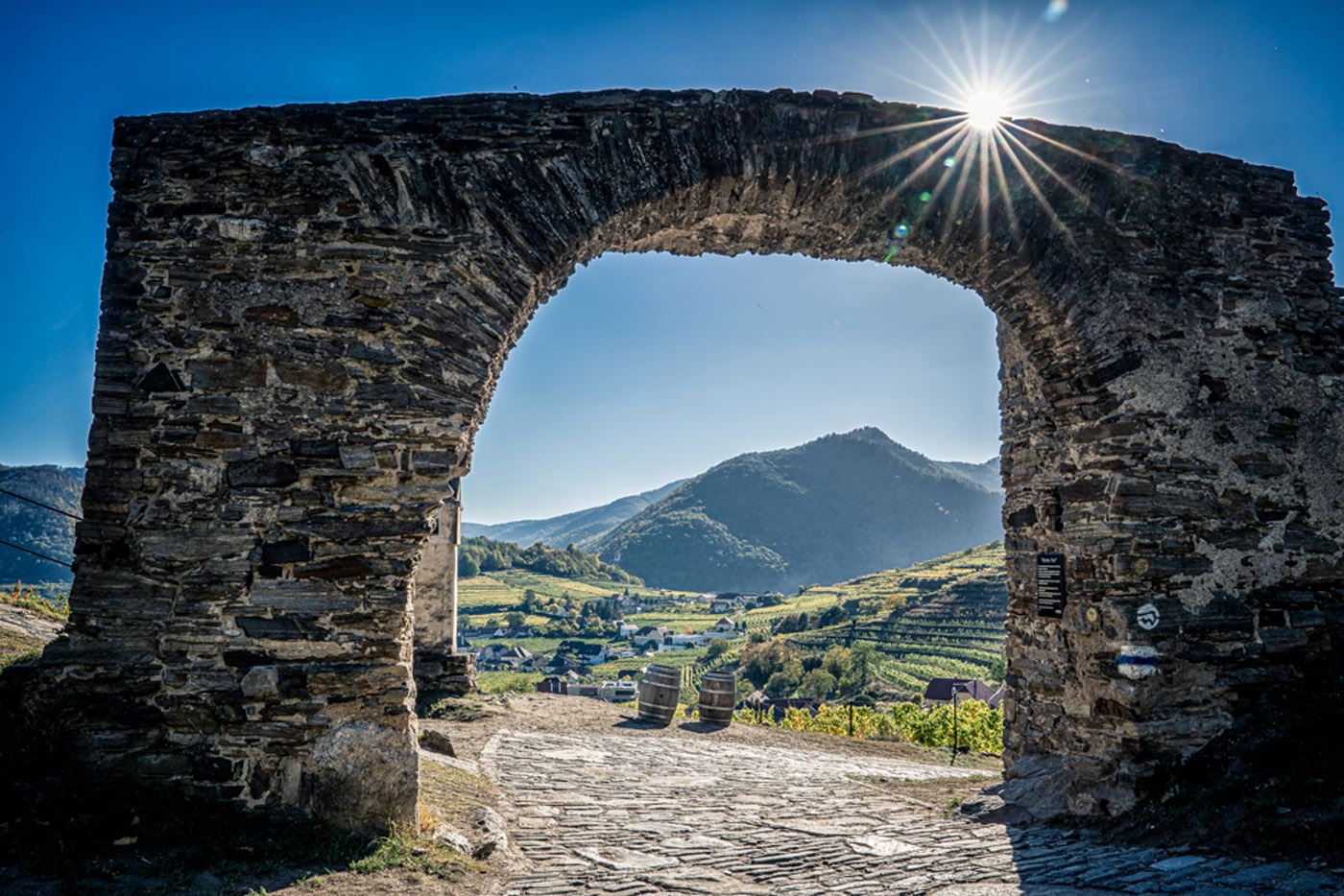 Herbstlicher Blick durch einen Steinbogen auf die Wachau